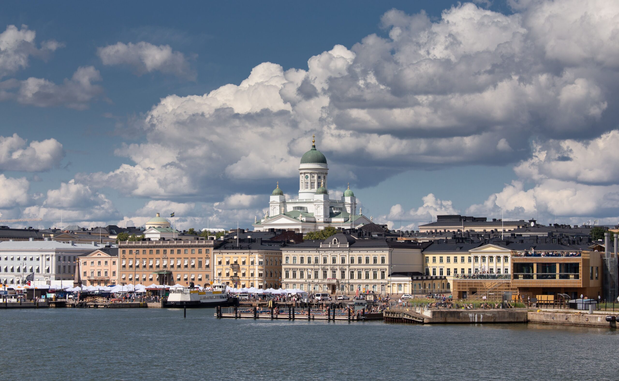 Adventures A stunning view of Helsinki's vibrant cityscape with the iconic Helsinki Cathedral under a dramatic sky.